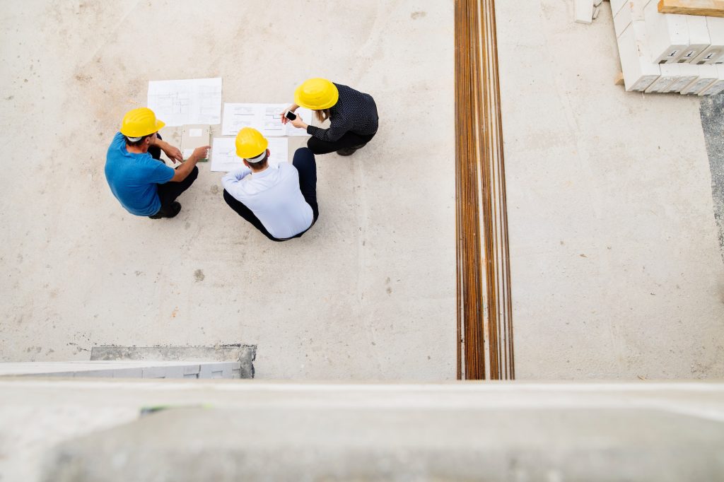 Architects and worker at the construction site.